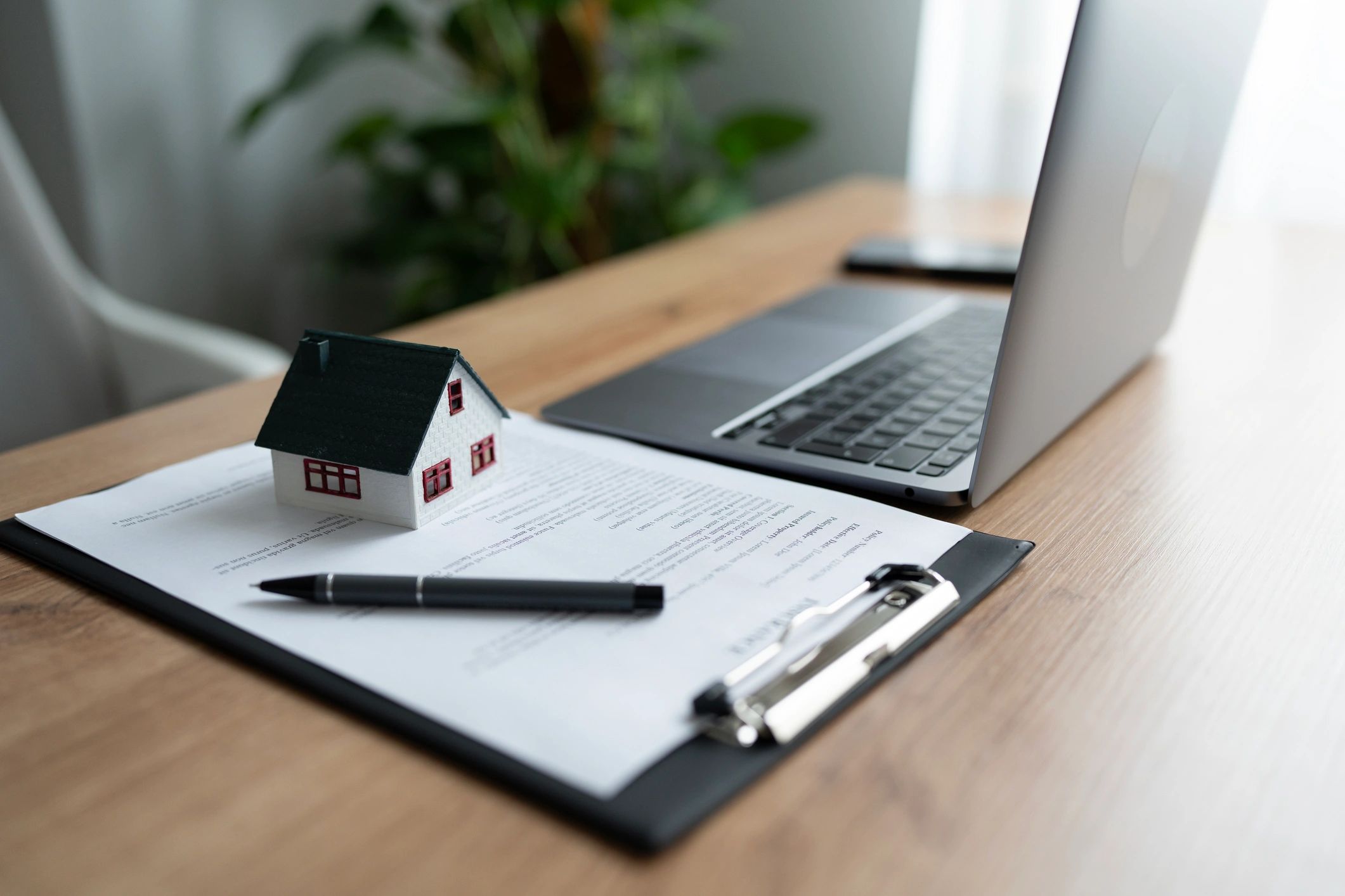 Purchase contract with house model and pen